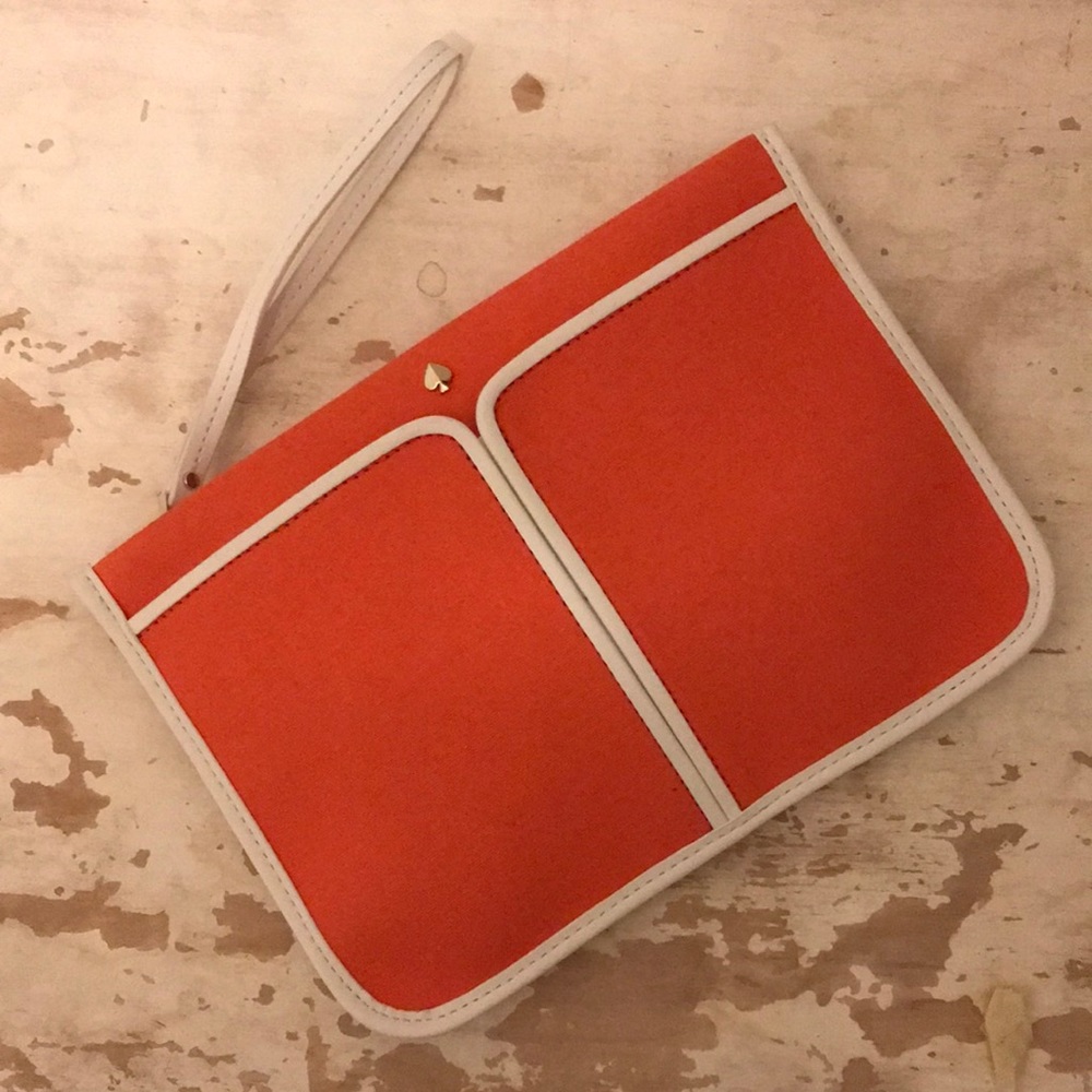 kate spade wristlet pouch orange and white canvas. Exterior pocket. Zip close